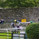Horses pass a few spectators watching the Behind Closed Doors action in the Old Park Wood Handicap Hurdle at Cartmel. 26/7/2020 Pic Steve Davies/Racingfotos.com