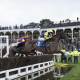 Ludlow Racecourse 2.12.20 The winner Roll Again (Robert Dunne) leads over the water jump in the 3m 1f handicap chase infront of the grandstand where race fans watch the racing on the first day spectators are allowed back to watch the action. Photo Edward Whitaker / Racingfotos.com